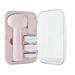 A pink facial cleansing device from Vanity Planet with three white brush attachments stored in a sleek case with a clear cover. The device and brushes are neatly organized in dedicated compartments.