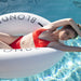 Close up photo of woman in a white swim ring with "the blonde" text